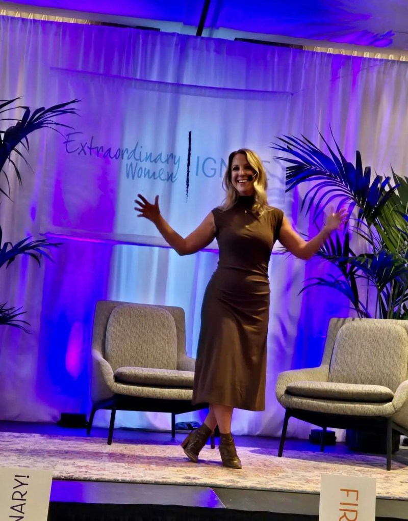 Emily Wishall presenting on somatics, nervous system regulation, and whole-body wellness at a live event.