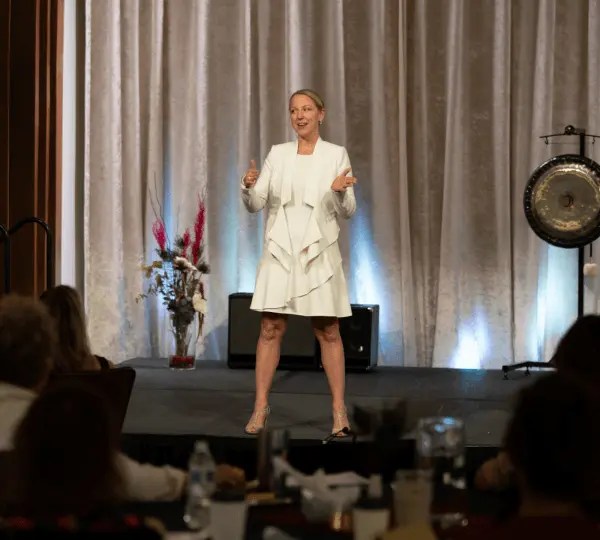 Emily Wishall presenting on somatic leadership, presence, and nervous system regulation to a live audience.