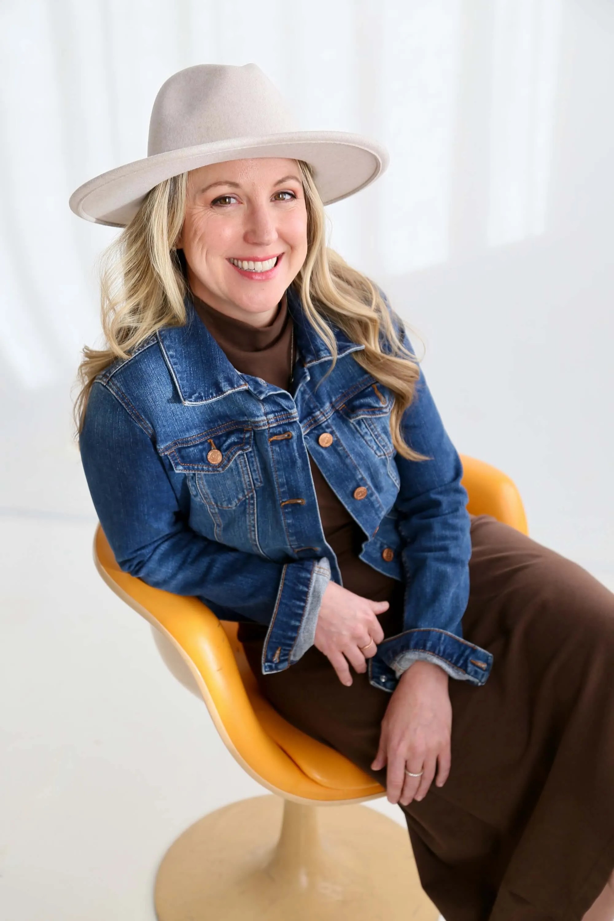 Emily Wishall, somatic coach and Certified Rolfer®, smiling in a welcoming portrait.