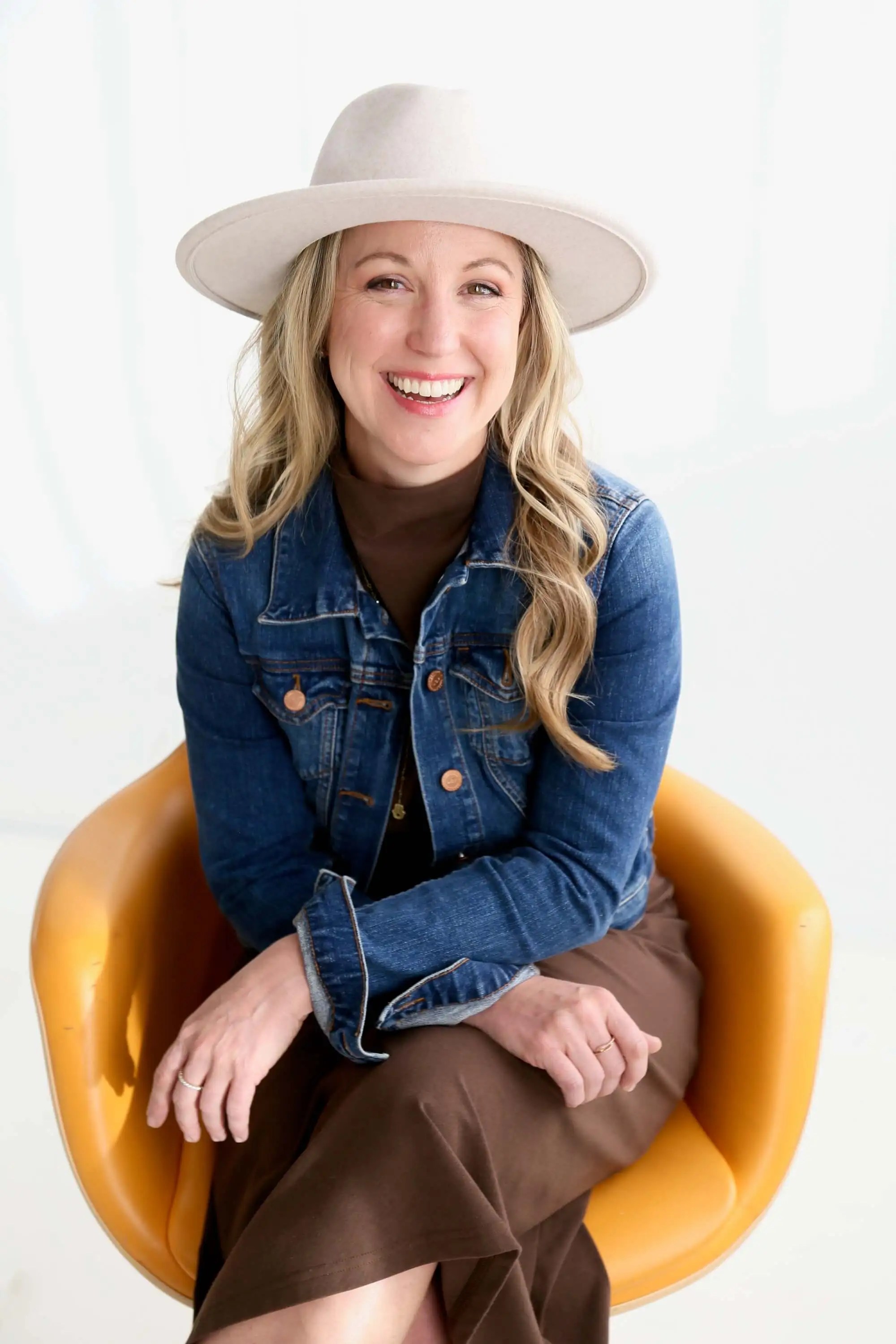 Emily Wishall smiling in a welcoming portrait that reflects her compassionate approach to somatic coaching.