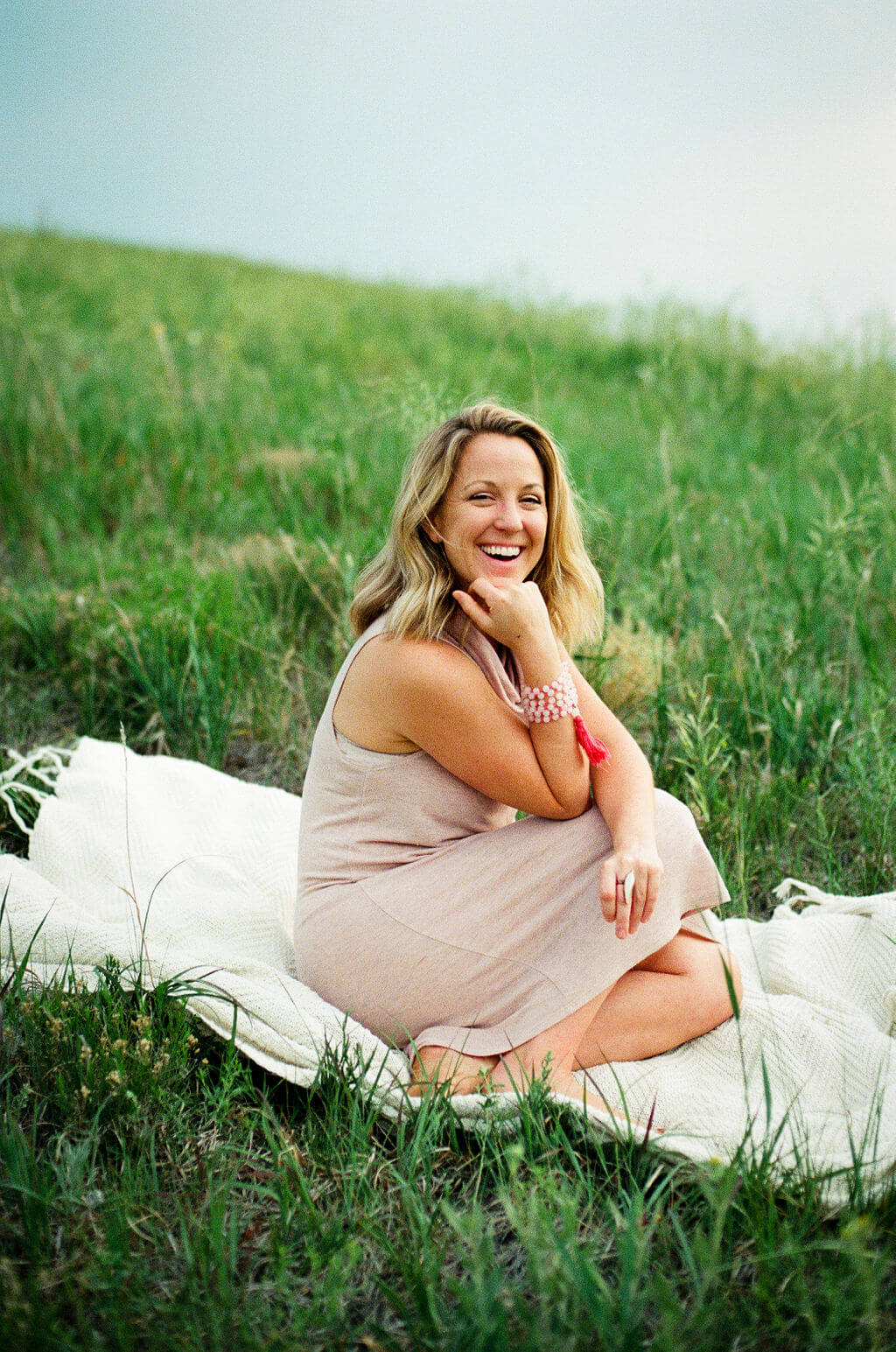 Emily Wishall smiling outdoors in a peaceful natural setting.